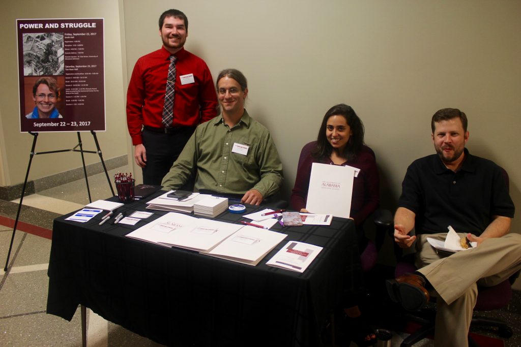 This image shows several graduate students manning the registration desk.