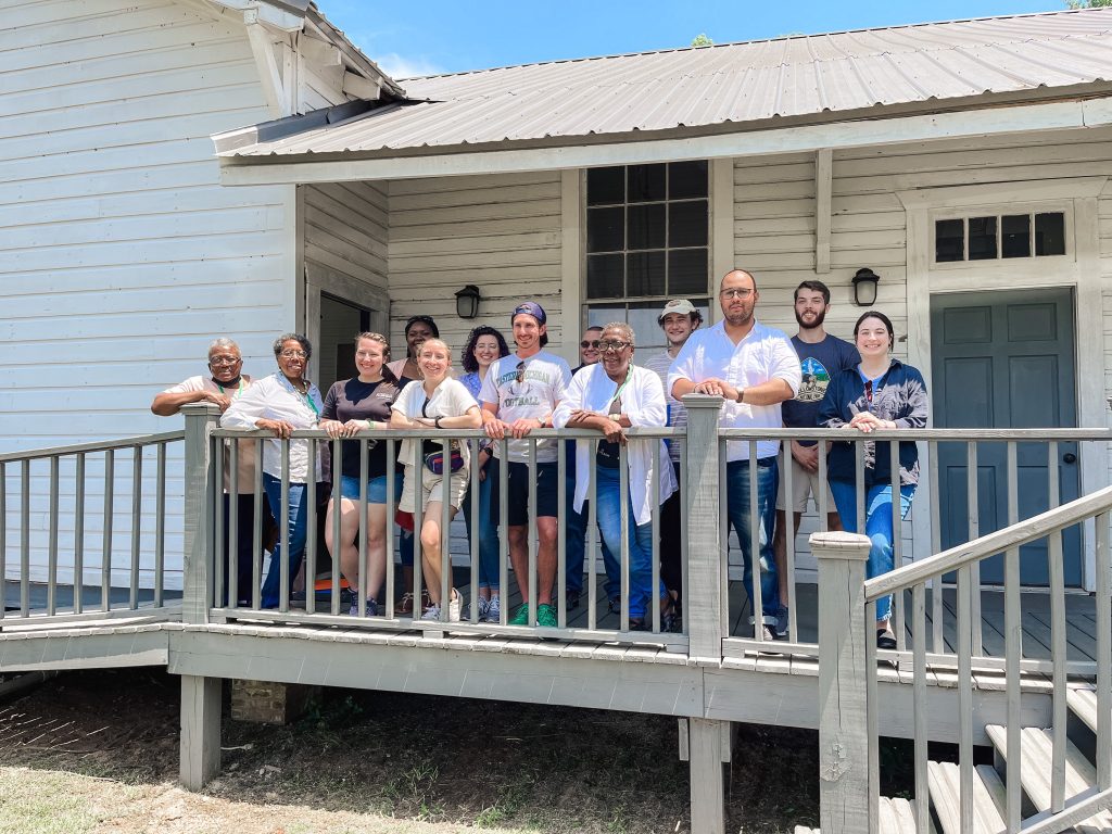 Students stand on the porch of the Rosenwald School. 