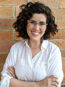 Profile image of Isabella Morales standing against a brick wall
