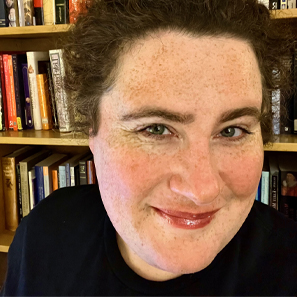 Profile image of Lucy Kaufman in front of a bookshelf.