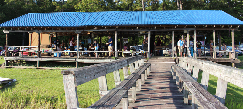 This image shows the Tuscaloosa Sailing Club pavilion and the party attendees sitting at tables. 