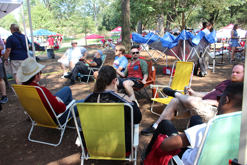 This image shows graduate students sitting in chairs at the tailgate.