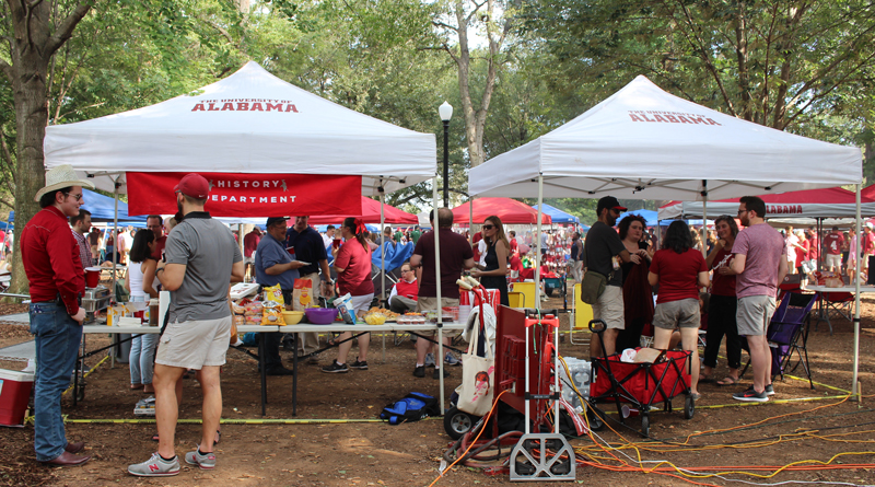 This image shows people mingling at the tailgate.