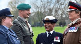 Four British servicemembers of diverse gender, racial, and sexual identities.