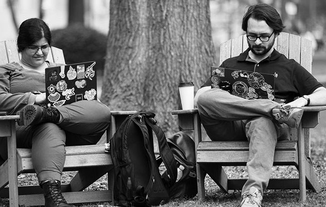 two students studying on the UA quad