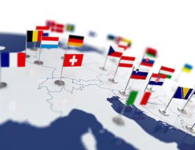 map studded with pins bearing flags of European nations