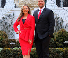 Dawn Wiley and Cody Brown in front of the UA president's mansion.