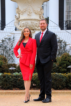 Dawn Wiley and Cody Brown in front of the UA president's mansion.