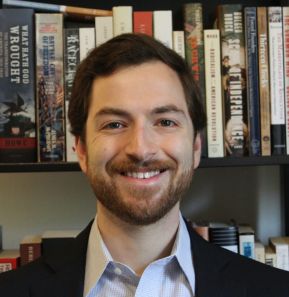 Profile image of Joe Angelillo in front of a bookshelf.